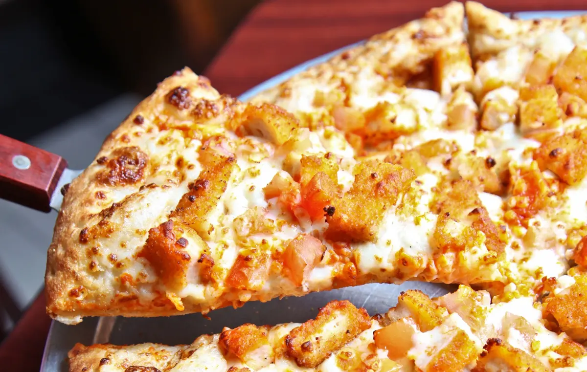 Fresh hand-tossed slice at Tropicana Pizza