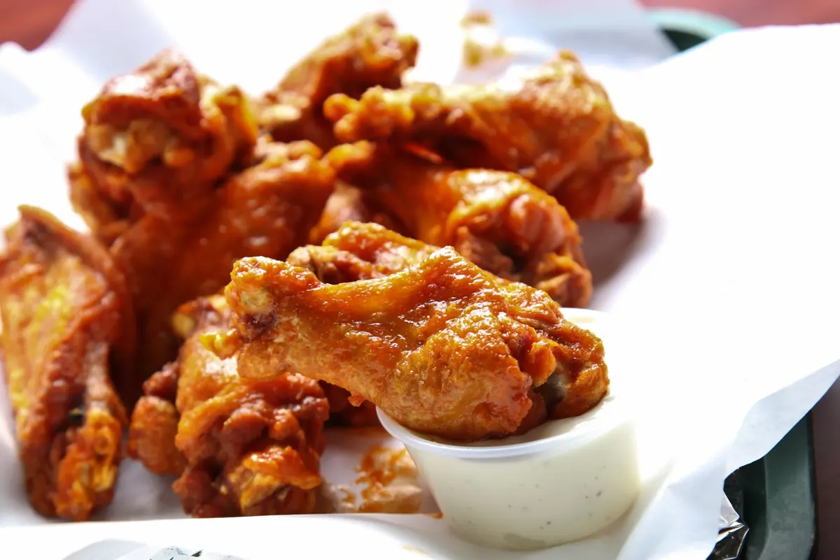Crispy wings served with house dressing